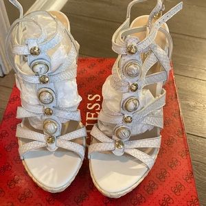 Snakeskin white with gold accents. Guess